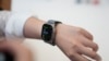 FILE - A person tries on an Apple Watch during an unveiling of new products on the Apple campus in Cupertino, California, Sept. 12, 2023.