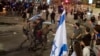Israeli police remove a person protesting against Israeli Prime Minister Benjamin Netanyahu's government as demonstrators call for the release of hostages held in the Gaza Strip by the Hamas militant group, in Tel Aviv, Israel, June 1, 2024.