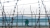 FILE - South Korean army soldiers patrol along the barbed-wire fence in Paju, South Korea, near the border with North Korea, Feb. 16, 2023. 