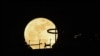 A super blue moon rises behind Marina Bay Sands observation deck in Singapore, Aug. 31, 2023. 