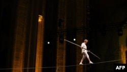Philippe Petit performs during his show Towering, at the Cathedral Church of St. John the Divine, in New York City on Aug. 8, 2024. 