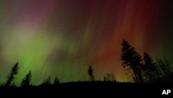 FILE - The Northern Lights are seen May 10, 2024, in Estacada, Ore. The National Oceanic and Atmospheric Administration said Aug. 12 that Earth had been hit by a solar storm that could bring the Northern Lights to night skies farther south than normal.