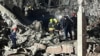 This handout photo, taken and released Jan. 16, 2024, by broadcast news station Kurdistan 24, shows firemen and security staff at the site of impact of a missile launched by Iran, in Irbil, the capital of Iraq's northern autonomous Kurdish region.