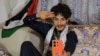 Rashed Al-Haddad, 19, a Yemeni TikToker and influencer, who has been dubbed 'Tim Houthi Chalamet' by Western internet wags for his resemblance to actor Timothee Chalamet, talks to a friend on the phone in Sanaa on Jan. 18, 2024.