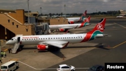 FILE - Kenya Airways planes are seen through a window at the Jomo Kenyatta international airport, in Nairobi, Kenya, Aug. 1, 2020.