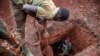 FILE - Tanzanian miners extract soil to look for gold at an open-pit gold mine in Nyarugusu, Geita Region, May 27, 2022. The collapse of an illegal gold mine killed at least 22 people in northern Tanzania following heavy rains, a senior government official said on Jan. 14, 2024.
