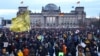 Participants gather during a demonstration against racism and far right politics in front of the Reichstag building in Berlin, Jan. 21, 2024. 