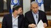 Israeli Prime Minister Benjamin Netanyahu, right, speaks with Minister of Finance Bezalel Smotrich during the weekly cabinet meeting at the Defense Ministry in Tel Aviv, Israel, Jan. 7, 2024.