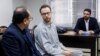 FILE - Swedish EU diplomat Johan Floderus, center, attends a court session in Tehran, Iran, Dec. 10, 2023. Floderus was arrested on Apr. 17, 2022, at Tehran airport as he was returning home from a trip with friends.