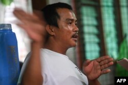 In this photo taken on August 8, 2022, fisherman Mariel Villamonte gestures during an interview with AFP in the village of Cato, Infanta town, Pangasinan province.