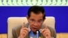 FILE - Cambodia's Prime Minister Hun Sen gestures during a press conference at the Peace Palace in Phnom Penh on September 17, 2021, as the country begins vaccinating children aged between six and 12. (Photo by TANG CHHIN Sothy / POOL / AFP)