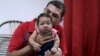 FILE - Glecion Fernando holds his 2-month-old son, Guilherme Soares Amorim, who was born with microcephaly, in Ipojuca, Brazil, Feb. 1, 2016. 