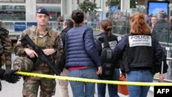 French police experts enter the cordoned off area after a knife attack at Gare de Lyon railway station, a major travel hub in Paris, on Feb. 3, 2024.