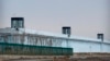 FILE - A person stands in a tower on the perimeter of the No. 3 Detention Center in Dabancheng in western China's Xinjiang Uyghur Autonomous Region on April 23, 2021. 
