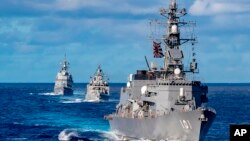 In this photo from the Defense Visual Information Distribution Service, a ship from Japan's Maritime Self-Defense Force sails during MALABAR 2021 on Aug. 27, 2021. The U.S., India and Australia also participated in the exercise, held in the Philippine Sea and Bay of Bengal.