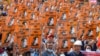 FILE - In this file photo taken on Feb. 28, 2021 protesters hold posters with the image of detained civilian leader Aung San Suu Kyi during a demonstration against the military coup in Naypyidaw, Myanmar.
