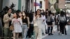 FILE - People wearing face masks to protect against the spread of the coronavirus go shopping in Taipei, Taiwan, Nov. 21, 2021.