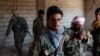 FILE - Kurdish fighters from the People's Protection Units (YPG) stand in a house in Raqqa, Syria, June 21, 2017. While welcoming the ouster of jihadist from the city, local Arabs are suspicious of the advancing Kurds' long-term intentions.