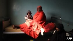 Une mère et son enfant dans une chambre du centre de santé d'Iferouane à Iferouane, le 30 novembre 2022.