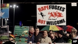 FILE - PEGIDA activists rally against the German government's refugee and migrant policies, in Leipzig, eastern Germany, Jan. 11, 2016. 
