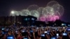 FILE - People use smartphones to film fireworks exploding at Tiananmen Square in Beijing on Oct. 1, 2019, as part of a gala evening commemorating the 70th anniversary of the founding of Communist China.