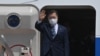 South Korean President Moon Jae-in waves from the steps of his plane as he leaves for the United States at Seoul Air Base in Seongnam, south of Seoul, on May 19, 2021. 