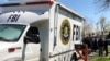 Law enforcement personnel including FBI agents are seen March 13, 2018, near a home that was hit with a parcel bomb in Austin, Texas. 