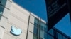 FILE - A Twitter logo hangs outside the company's San Francisco offices on Nov. 1, 2022. 