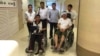 Cambodian opposition​ CNRP lawmakers Nhay Chamroeun and Kong Saphea are seen in wheelchairs at Phyathai hospital in Bangkok on Tuesday, October 27, 2015 after being beaten by protesters in Phnom Penh, Cambodia on Monday. (Courtesy of Nhay Chamroeun)
