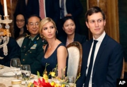 FILE - Ivanka Trump, second from right, the daughter and assistant to President Donald Trump, is seated with her husband, White House senior adviser Jared Kushner, right, during a dinner with President Donald Trump and Chinese President Xi Jinping at Mar-a-Lago in Palm Beach, Florida, April 6, 2017. Earlier in the day, Ivanka Trump's company received provisional approval from the Chinese government for three new trademarks, winning monopoly rights to sell Ivanka brand jewelry, bags and spa services in the world's second-largest economy.