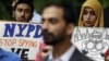 FILE - People hold signs while attending a rally to protest New York Police Department surveillance tactics near police headquarters in New York, Aug. 28, 2013. 