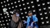 People seen along along 53rd Street wear personal protective equipment during the global outbreak of coronavirus disease (COVID-19) in Chicago, Illinois, April 7, 2020.