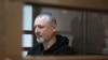 FILE - Igor Girkin, a hardline nationalist critic of Russian President Vladimir Putin, sits inside a defendant's cage at Moscow City Court on Oct. 17, 2023. Prosecutors asked a judge to jail Girkin for nearly five years on extremist charges on Jan. 18, 2024.