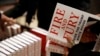 FILE - A customer looks at a copy of Michael Wolff's 'Fire and Fury: Inside the Trump White House' as they go on sale at a bookshop, in London, Jan. 9, 2018. 