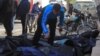 A man attempts to identify bodies after what activists said were airstrikes carried out by the Russian air force in Idlib city, Syria, Dec. 20, 2015.