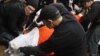 FILE - Protesters perform a simulation of the waterboarding torture technique on a man dressed as a prisoner during a protest, marking the fifth anniversary of the U.S.-led invasion of Iraq, in front of the White House in Washington, March 19, 2008. 