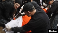 FILE - Protesters perform a simulation of the waterboarding torture technique on a man dressed as a prisoner during a protest, marking the fifth anniversary of the U.S.-led invasion of Iraq, in front of the White House in Washington, March 19, 2008. 