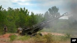 Des soldats ukrainiens tirent sur des positions russes à partir d'un obusier M777 fourni par les États-Unis dans la région de Donetsk, dans l'est de l'Ukraine, le 18 juin 2022.