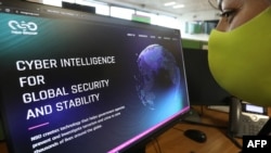 A woman checks the website of Israel-made Pegasus spyware at an office in the Cypriot capital Nicosia, July 21, 2021.