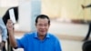 Cambodian Prime Minister Hun Sen, of the Cambodian People's Party (CPP), holds his ballot before dropping it into a ballot box at a polling station in Takhmua in Kandal province, southeast of Phnom Penh, Cambodia, June 5, 2022. 