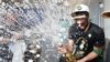 Boston Celtics forward Jayson Tatum sprays champagne while celebrating after defeating the Dallas Mavericks in Game 5 to win the NBA basketball finals June 17, 2024, in Boston.