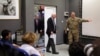 U.S. Sen. John McCain, center, arrives for a press conference at the Resolute Support headquarters in Kabul, Afghanistan, July 4, 2017. 