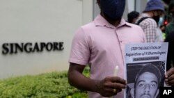 Activists attend a candlelight vigil against the impending execution of Nagaenthran K. Dharmalingam, sentenced to death for trafficking heroin into Singapore, outside the Singaporean embassy in Kuala Lumpur, Malaysia, Nov. 8, 2021.