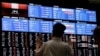 Media members observe the stock quotation board at the Tokyo Stock Exchange in Tokyo, Japan, Aug. 6, 2024.