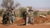 FILE - Rebel fighters gather during their advance toward the Islamic State-held city of al-Bab, northern Syria, Oct. 26, 2016. 