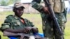 Waasi wa M23 wakiwa karibu na sehemu iliyowekwa kizuizi cha wamajeshi wa umoja wa mataifa, Kanyaruchinya, kaskazini mwa Goma. May 15,2013