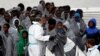 FILE - Migrants disembark from Italian Coast Guard patrol vessel Diciotti in the Sicilian harbor of Catania, Italy, Nov. 16, 2016. Nearly 11,000 asylum-seekers and economic migrants, mainly from African nations, arrived on Italian shores in a four-day period, June 24-27.