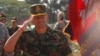 Lt. Gen. Hun Manet, son of Cambodian Prime Minister Hun Sen and deputy commander of the Royal Cambodian Army and commander of the National Counter Terror Special Force, walks through honorary guards as his arrives for presiding over a U.S.-backed peacekeeping exercise dubbed "Angkor Sentinel 2014" at the Cambodian tank command headquarters in Kampong Speu province, 60 kilometers (37 miles) west of Phnom Penh, Cambodia, Monday, April 21, 2014. (AP Photo/Heng Sinith)