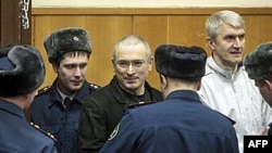 Mixail Xodorkovski (ortada) və Platon Lebedev (sağda) Moksvada məhkəmə zalında, 27 dekabr 2010