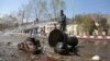Afghan firefighters clean up the site of a deadly suicide bombing near Kabul University, in Kabul, March 21, 2018. 